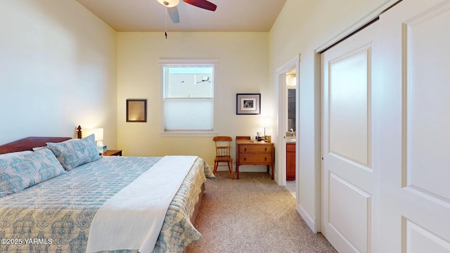 bedroom with light carpet and a ceiling fan