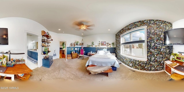 bedroom featuring ensuite bath, vaulted ceiling, and recessed lighting