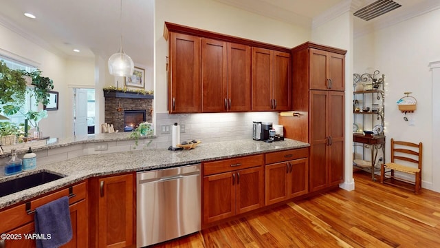 kitchen featuring tasteful backsplash, ornamental molding, light stone countertops, light wood-type flooring, and stainless steel dishwasher