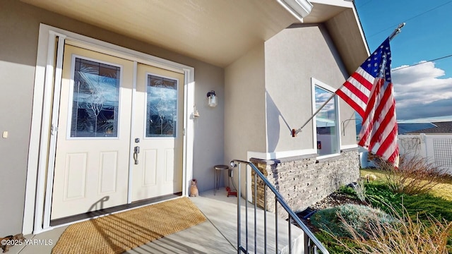 property entrance with stucco siding