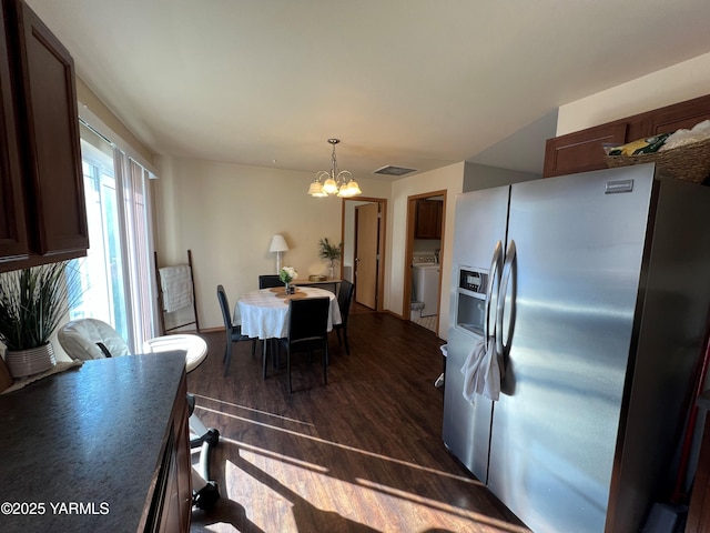 1215 Vineyard Dr, Tieton, WA 98947 - kitchen featuring stainless steel fridge with ice dispenser, a chandelier, dark wood-type flooring, washer / dryer, and decorative light fixtures