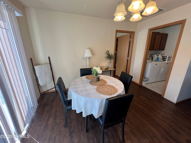 1215 Vineyard Dr, Tieton, WA 98947 - dining area with washer and clothes dryer, dark wood finished floors, and a chandelier
