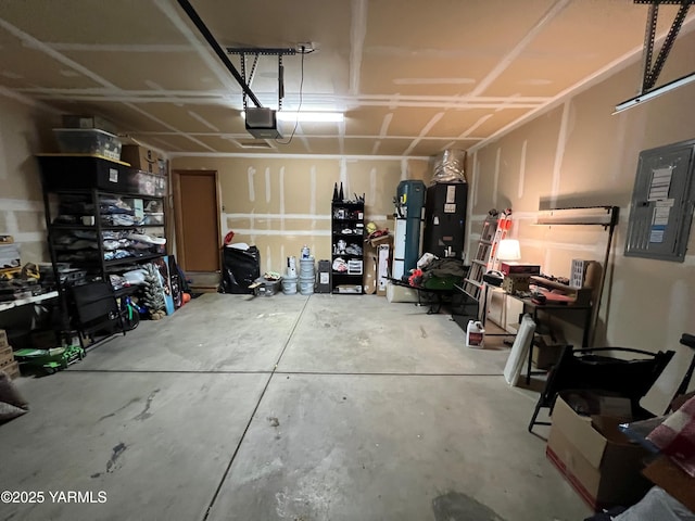 1215 Vineyard Dr, Tieton, WA 98947 - garage featuring a garage door opener, electric panel, and refrigerator