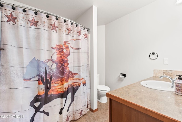 bathroom with toilet, vanity, and a shower with shower curtain