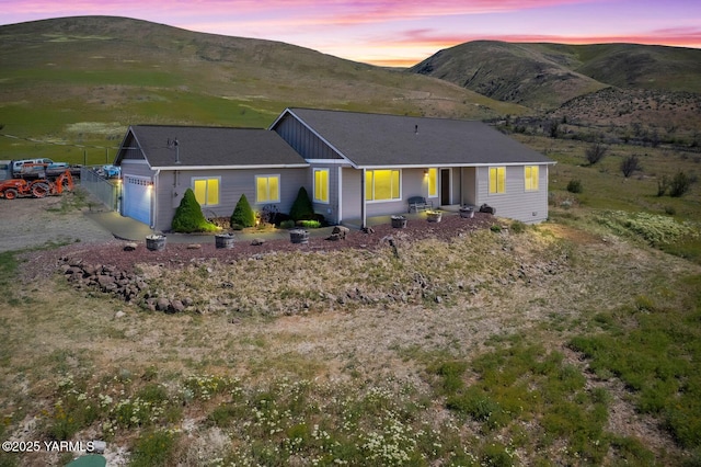 ranch-style house featuring a mountain view and a garage