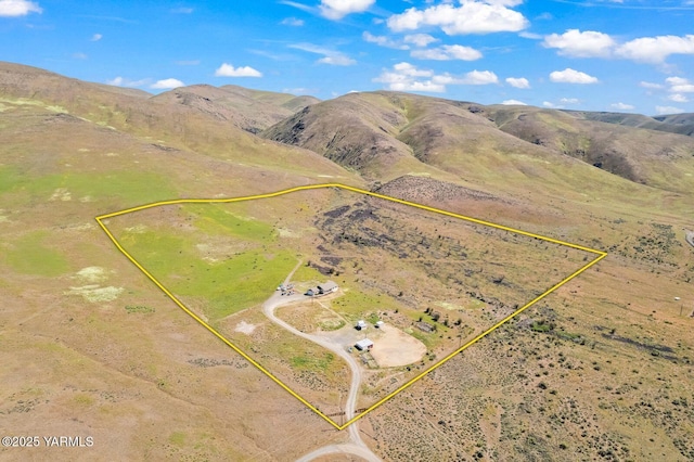 aerial overview of property's location featuring property boundaries highlighted and a mountain backdrop