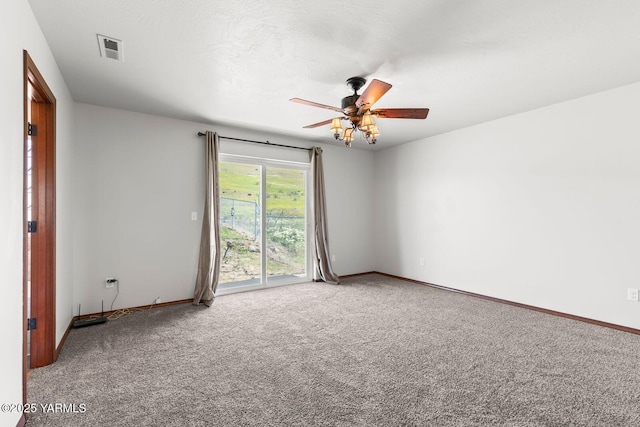 empty room featuring carpet flooring, ceiling fan, and baseboards