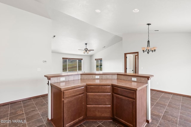 kitchen with lofted ceiling, a chandelier, baseboards, decorative light fixtures, and ceiling fan