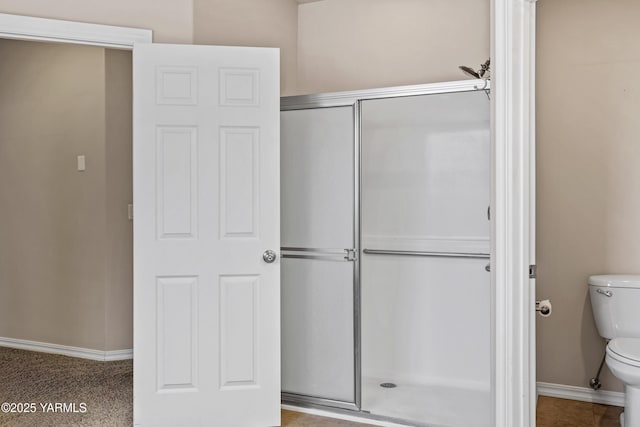 1008 S 91st Ave, Yakima, WA 98908 - bathroom with toilet, a shower stall, and baseboards