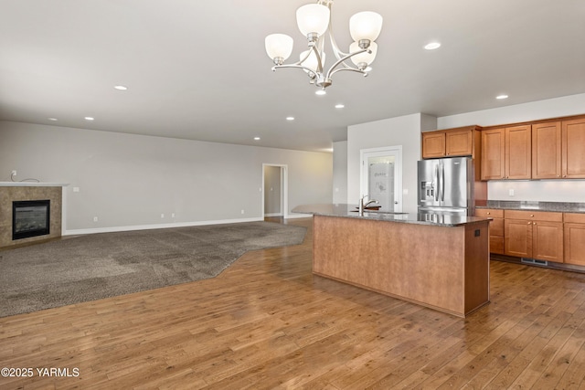 1008 S 91st Ave, Yakima, WA 98908 - kitchen featuring stainless steel fridge, a chandelier, wood-type flooring, open floor plan, and recessed lighting