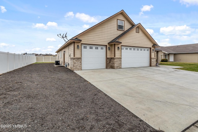1008 S 91st Ave, Yakima, WA 98908 - view of property exterior featuring concrete driveway, brick siding, and a garage