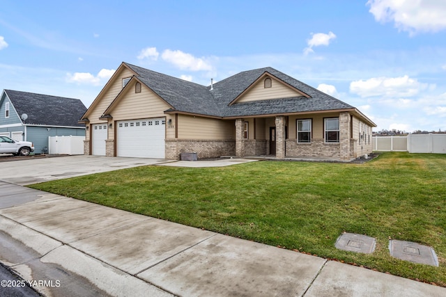 1008 S 91st Ave, Yakima, WA 98908 - view of front facade with brick siding, an attached garage, concrete driveway, covered porch, and a shingled roof