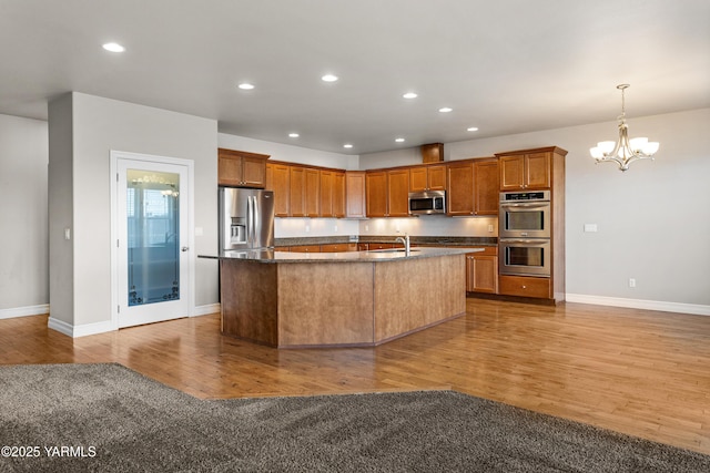 1008 S 91st Ave, Yakima, WA 98908 - kitchen featuring appliances with stainless steel finishes, a chandelier, light wood-style flooring, baseboards, and recessed lighting