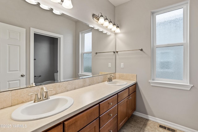 1008 S 91st Ave, Yakima, WA 98908 - bathroom featuring double vanity, baseboards, toilet, and tile patterned floors