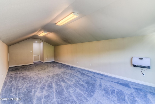 additional living space with carpet floors, vaulted ceiling, and baseboards