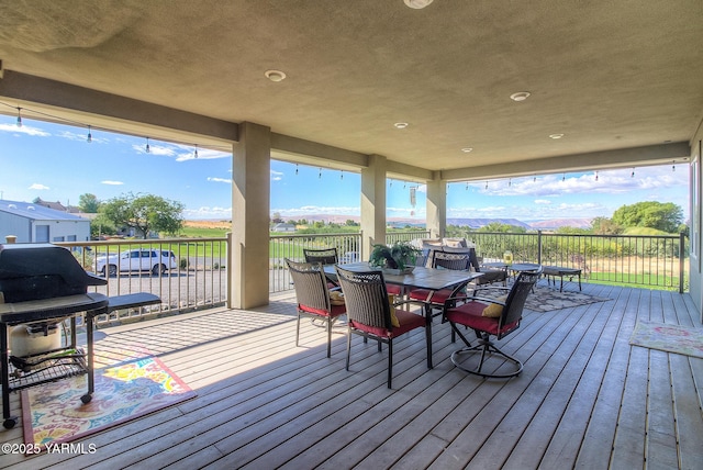 wooden terrace featuring outdoor dining area