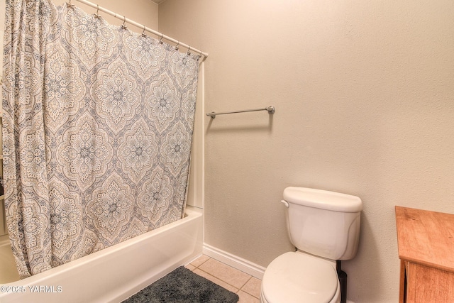 full bathroom with toilet, tile patterned flooring, baseboards, and shower / tub combo with curtain