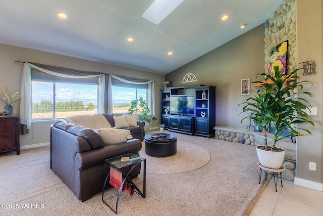 living room with a skylight, plenty of natural light, light tile patterned floors, and recessed lighting