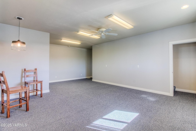 interior space with ceiling fan, baseboards, and carpet flooring