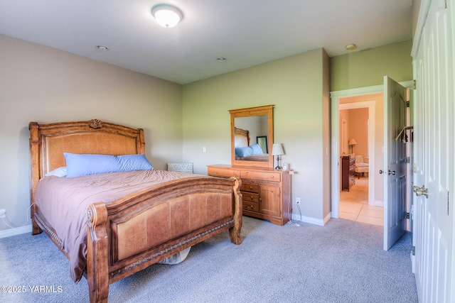 bedroom with light carpet and baseboards