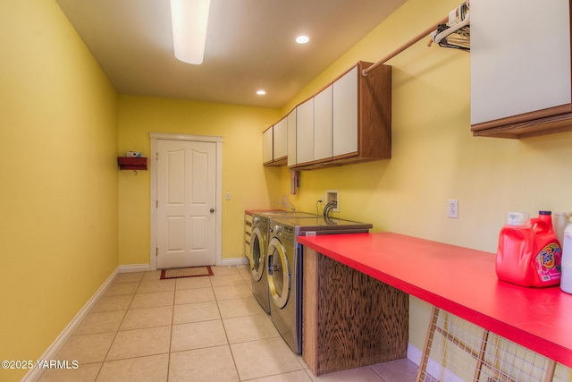 laundry area with washer and clothes dryer, light tile patterned floors, recessed lighting, cabinet space, and baseboards