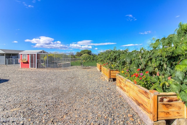 view of yard featuring an outdoor structure, exterior structure, and a garden