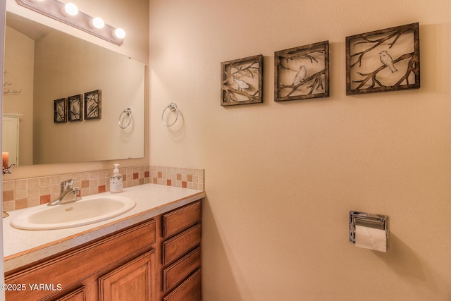 bathroom with tasteful backsplash and vanity