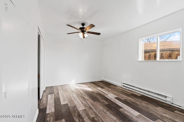 spare room featuring a ceiling fan, baseboards, baseboard heating, and wood finished floors