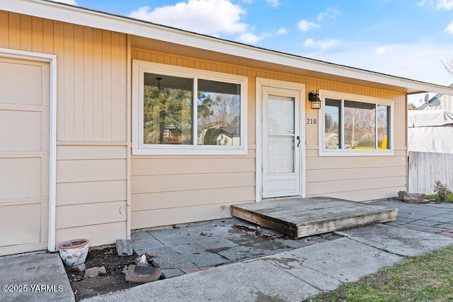 entrance to property with a garage and fence