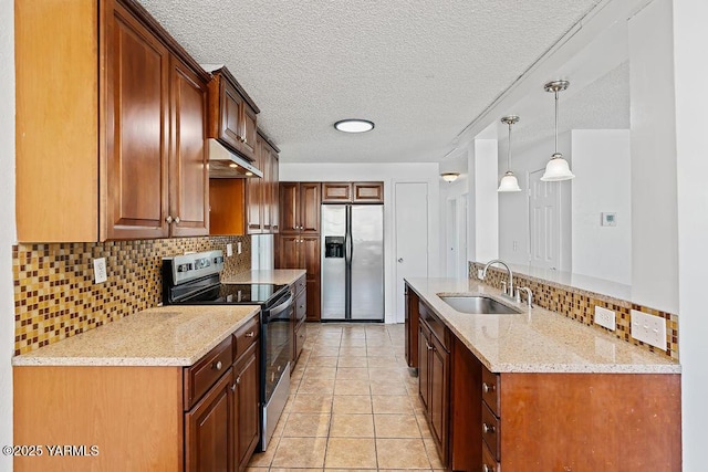 kitchen featuring decorative backsplash, appliances with stainless steel finishes, light stone countertops, under cabinet range hood, and a sink