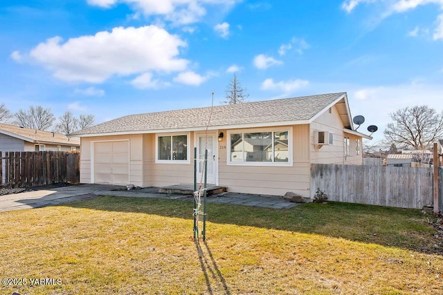 view of front of house with a garage, driveway, a front yard, and fence