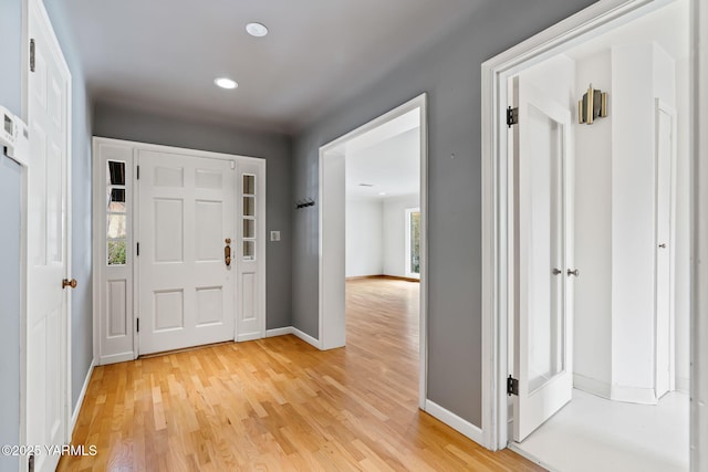 entryway featuring light wood finished floors, recessed lighting, and baseboards