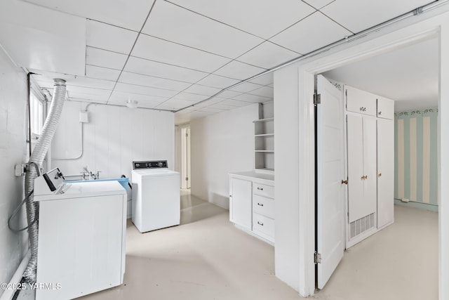 washroom with washing machine and dryer, laundry area, visible vents, and a sink