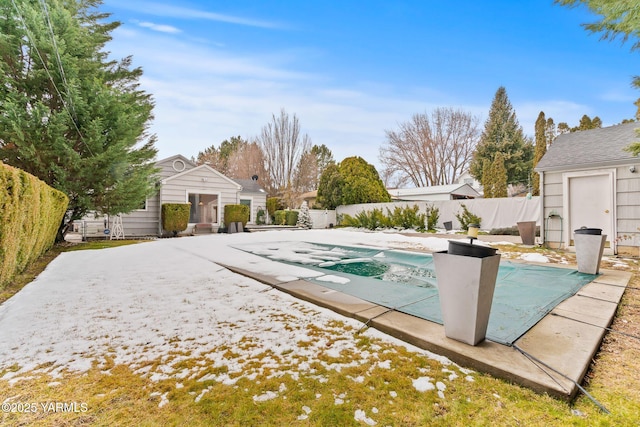 view of pool with an outbuilding, a patio area, a fenced backyard, and a fenced in pool