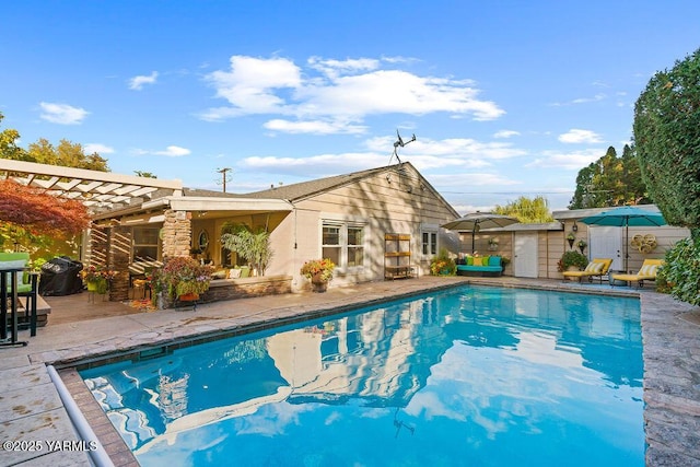 pool featuring an outdoor structure, grilling area, a pergola, and a patio