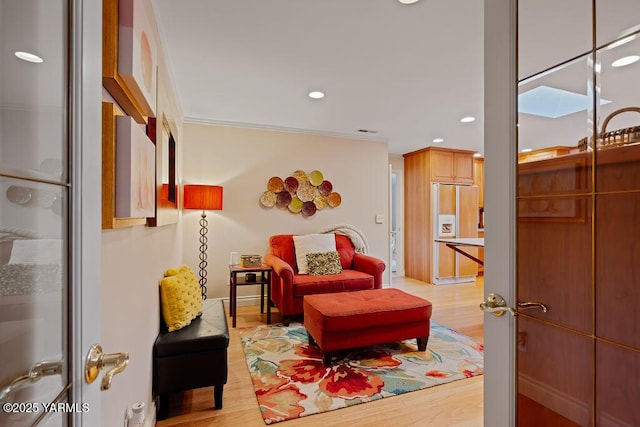 living area featuring light wood finished floors, visible vents, ornamental molding, and recessed lighting