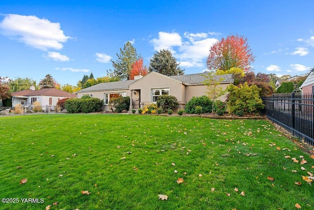 ranch-style home with fence private yard, a front lawn, and stucco siding