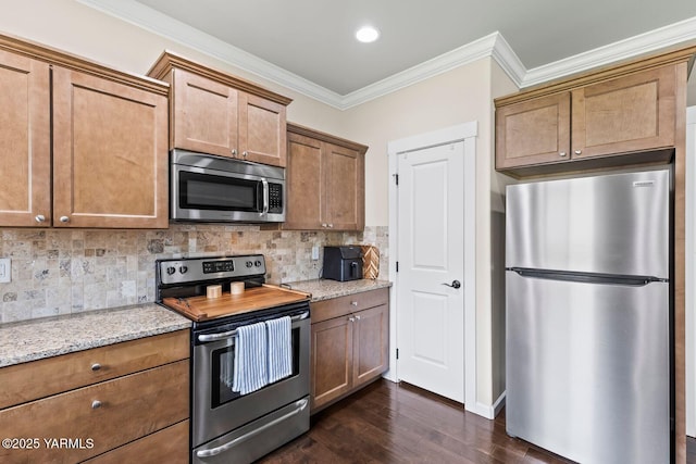 1504 W Naches Ave, Selah, WA 98942 - kitchen with stainless steel appliances, dark wood finished floors, ornamental molding, light stone counters, and decorative backsplash