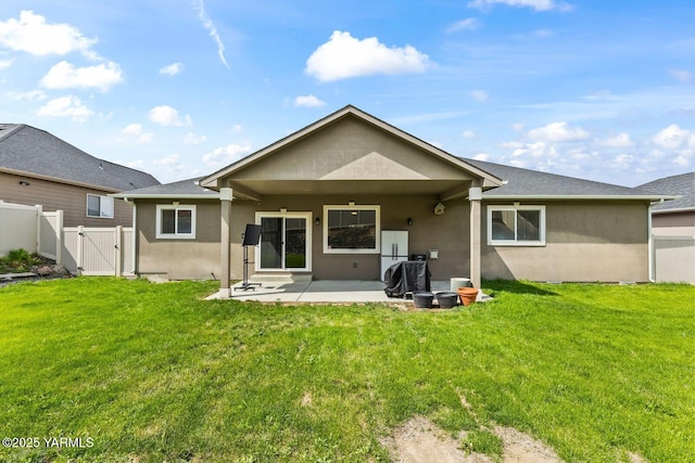 1504 W Naches Ave, Selah, WA 98942 - back of property with stucco siding, a gate, and a patio area
