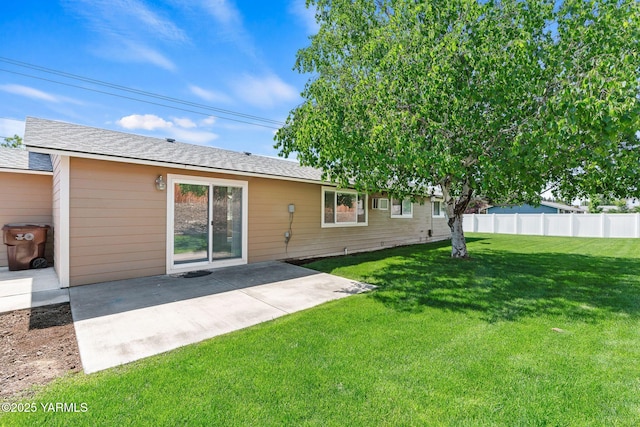 202 N 80th Ave, Yakima, WA 98908 - back of property featuring a lawn, a patio area, a shingled roof, and fence
