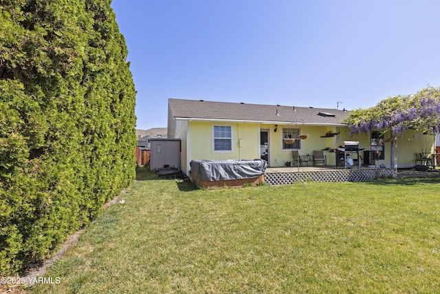 5602 Mount Clemens Way, Yakima, WA 98901 - rear view of house with a jacuzzi, a lawn, and a deck