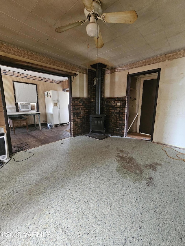 10585 US Highway 12, Naches, WA 98937 - unfurnished living room with a wood stove and ceiling fan