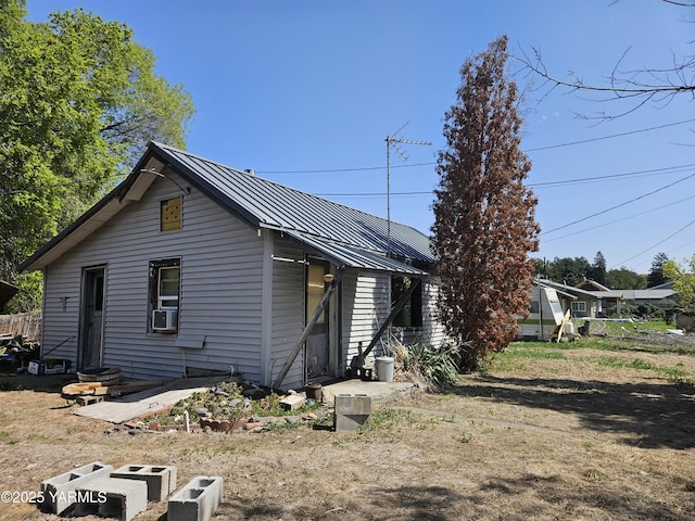 exterior space featuring metal roof and entry steps