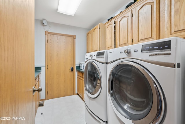 laundry area with light floors, visible vents, wallpapered walls, cabinet space, and independent washer and dryer