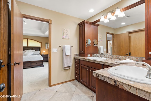 ensuite bathroom with double vanity, visible vents, ensuite bathroom, and a sink