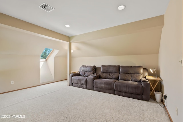 carpeted home theater featuring vaulted ceiling with skylight, baseboards, and visible vents