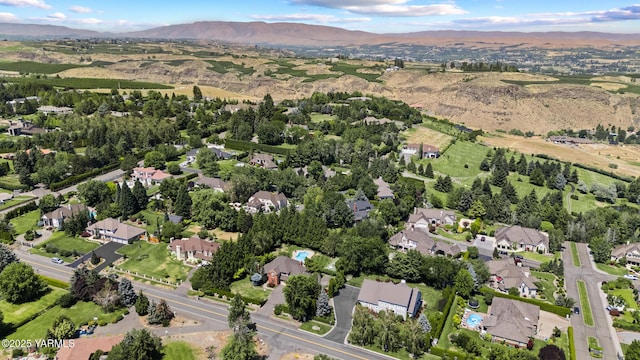 drone / aerial view featuring a residential view and a mountain view