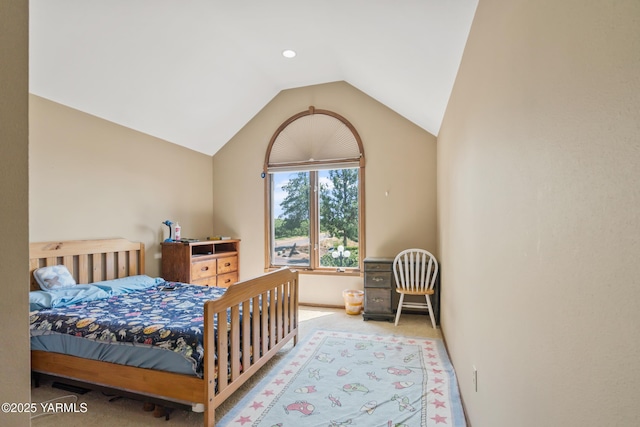 bedroom with lofted ceiling and carpet flooring