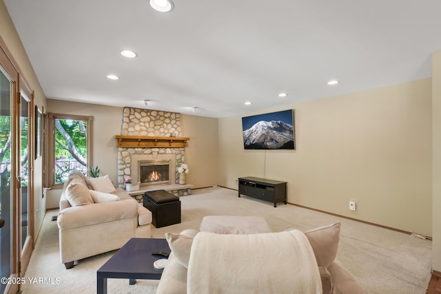 living area featuring light carpet, recessed lighting, a fireplace, and baseboards