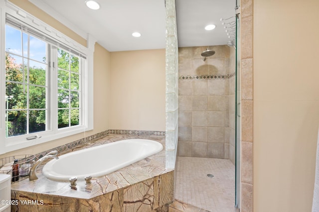 bathroom featuring a bath, recessed lighting, and tiled shower